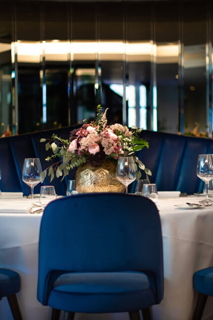 Elegant luxury table setting with blue velvet chairs for a wine dinner at Chapter One.