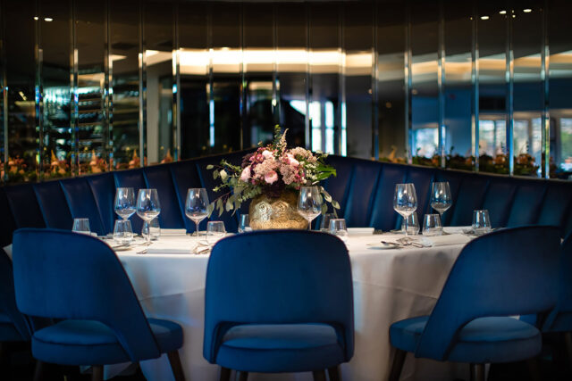Elegant luxury table setting with blue velvet chairs for a wine dinner at Chapter One.