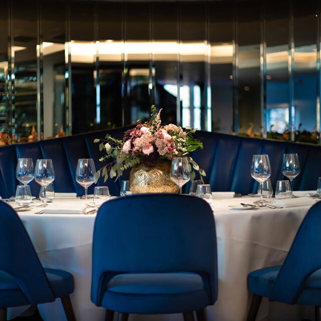Elegant luxury table setting with blue velvet chairs for a wine dinner at Chapter One.
