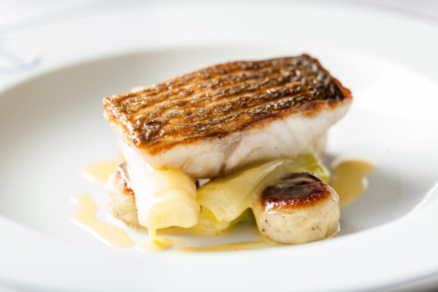 Mibrasa grilled fish with crispy skin, leeks, and gnocchi at Chapter One Kent.