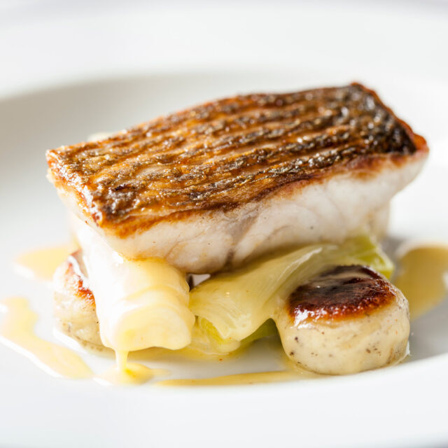 Mibrasa grilled fish with crispy skin, leeks, and gnocchi at Chapter One Kent.